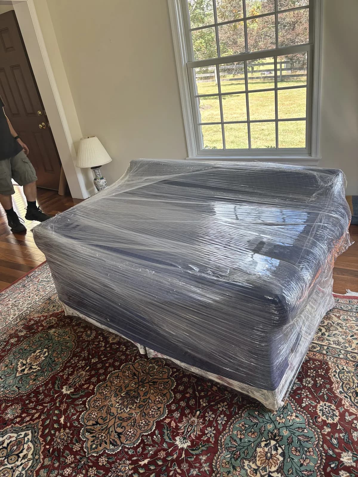A sofa fully wrapped in plastic before loading
